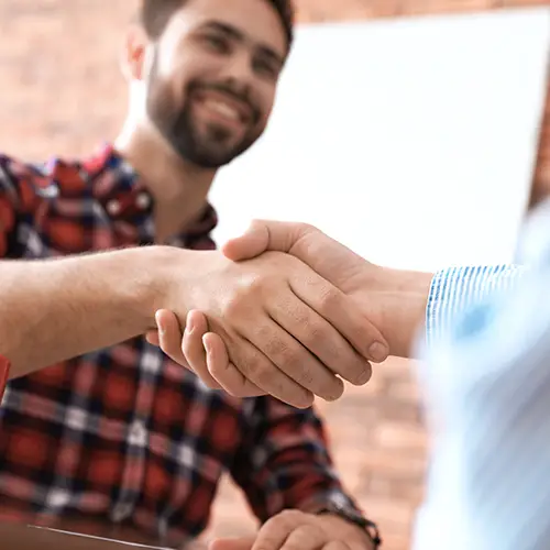 Two men shaking hands over approved financing terms | Nemeth Family Interiors