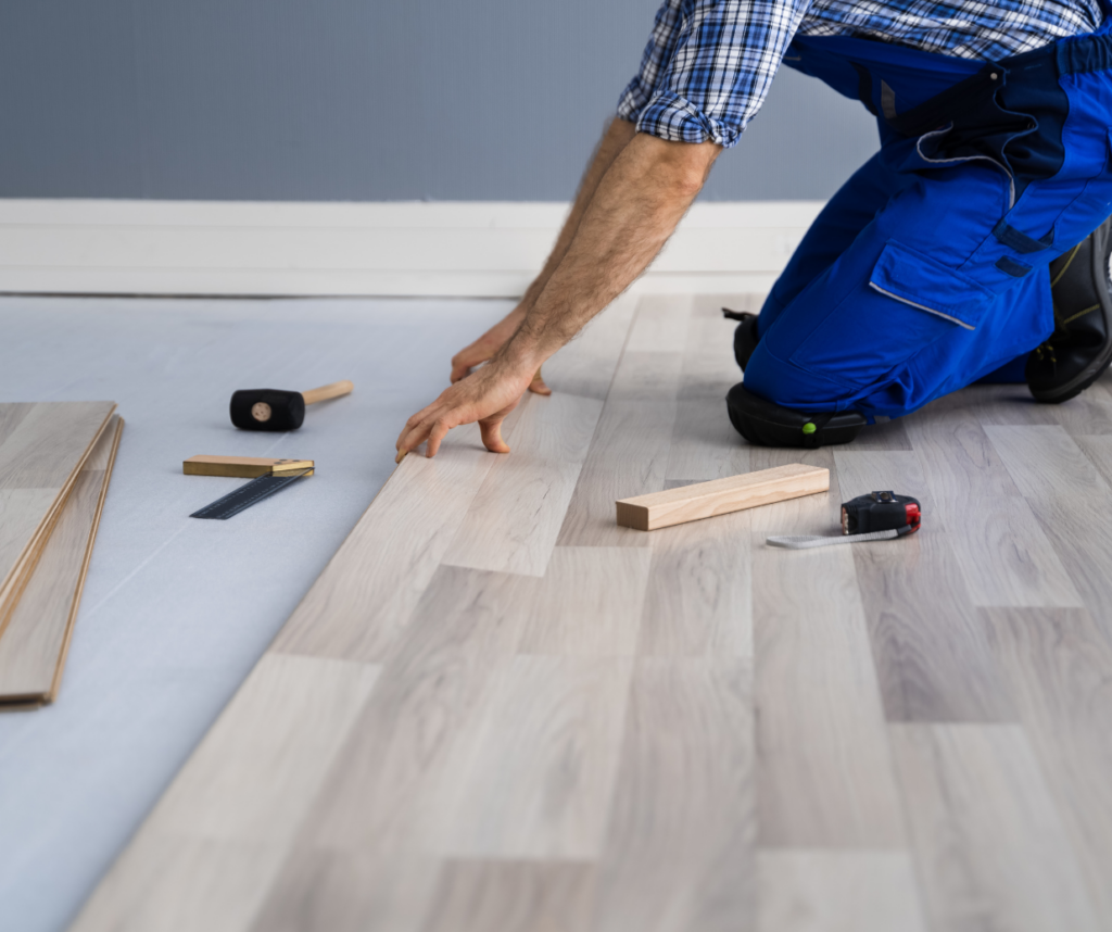 Flooring installer laying luxury vinyl planks